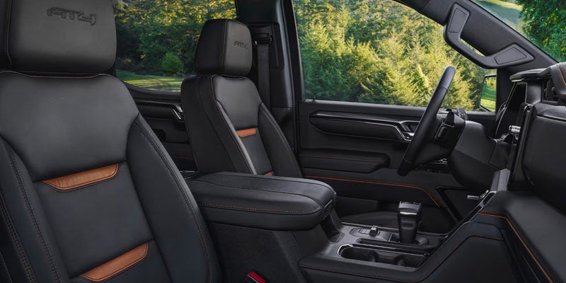 Natchez GMC Sierra 1500 interior featuring black leather front seats with contrast stitching